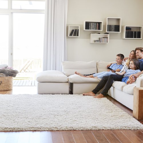 relaxing on a white couch and keep your feet warm with the area rug from Expressway Carpet in Mobile, AL